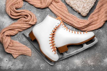 Ice skates and warm scarf on gray backgroundの写真素材
