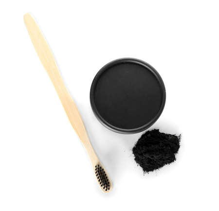 Activated charcoal tooth powder and toothbrush on white backgroundの写真素材