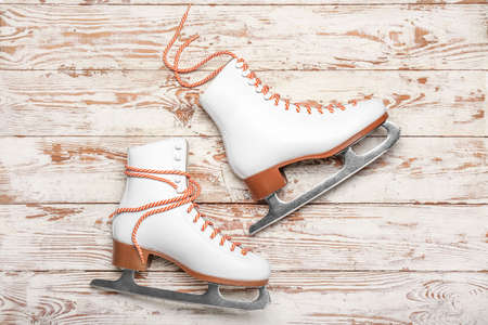 Ice skates on wooden background