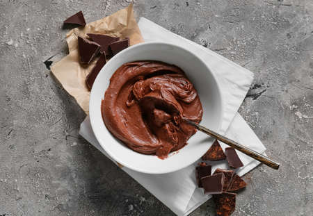Bowl with fresh dough for preparing chocolate brownie on gray backgroundの写真素材