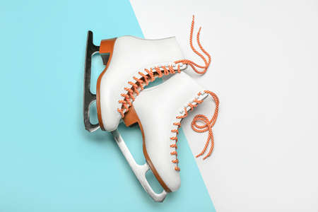 Stylish ice skates on color background