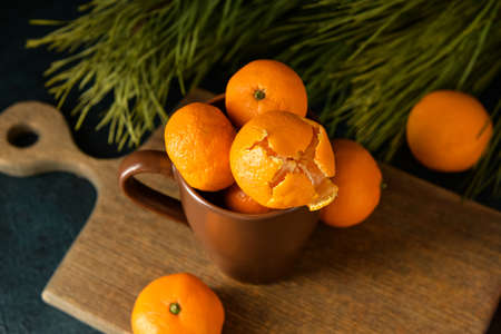 Cup with tangerines on wooden board, closeupの写真素材