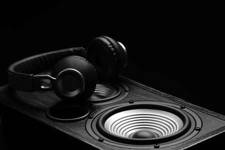 Modern loudspeaker and headphones on dark background, closeupの写真素材
