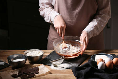 Woman preparing chocolate brownie at kitchen table, closeupの写真素材