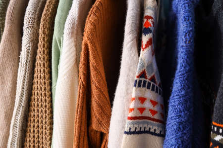 Closeup view of different knitted sweatersの写真素材