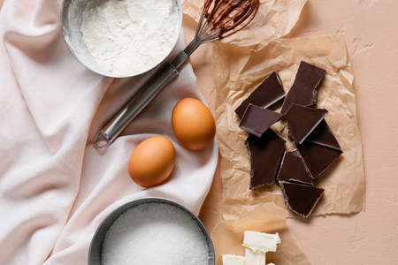 Fresh ingredients for preparing chocolate brownie on beige backgroundの写真素材