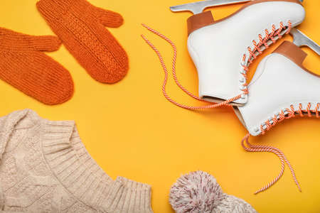 Frame made of ice skates and clothes on orange backgroundの写真素材