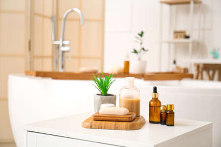 Soap, plant and cosmetic products on table in bathroomの写真素材