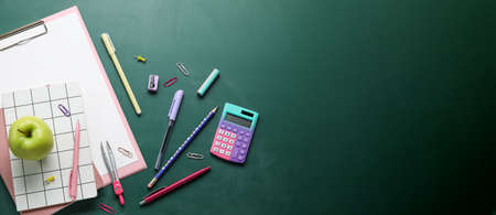 Set of school supplies with apple on chalkboard with space for textの写真素材