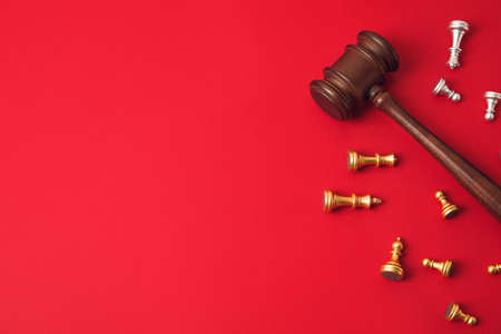 Judge gavel and chess pieces on color backgroundの写真素材