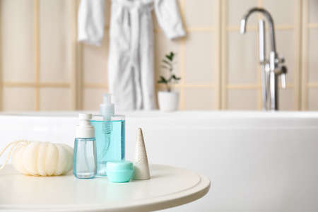 Sponge and cosmetic products on table in bathroomの写真素材