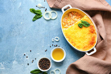 Baking dish with tasty English fish pie on blue backgroundの写真素材