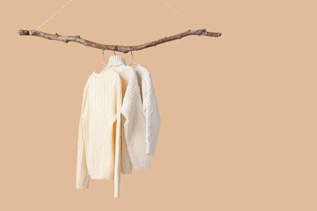 Children's sweaters hanging on color backgroundの写真素材