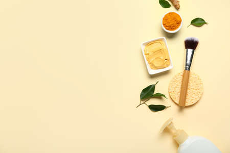 Composition with turmeric mask, powder and makeup brush on beige backgroundの写真素材