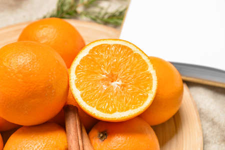 Plate with fresh oranges on table, closeup