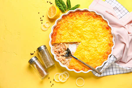 Baking dish with tasty English fish pie on yellow backgroundの写真素材