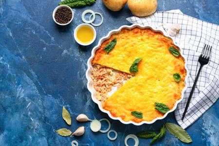 Baking dish with tasty English fish pie on blue backgroundの写真素材