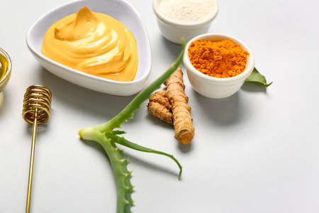 Bowl with turmeric mask, powder and aloe on gray background, closeupの写真素材