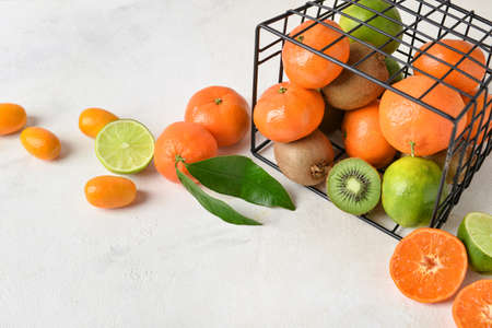 Basket with juicy fruits on light background, closeupの写真素材