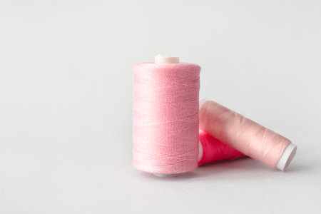 Multicolored sewing thread spools on light backgroundの写真素材