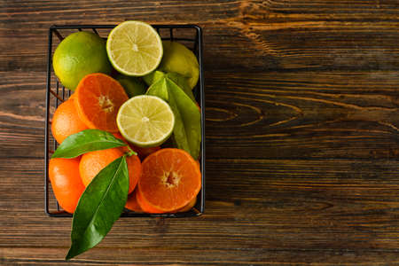 Basket with juicy fruits on wooden backgroundの写真素材