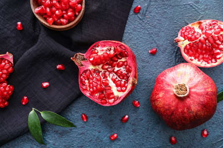 Ripe delicious pomegranates on dark backgroundの写真素材
