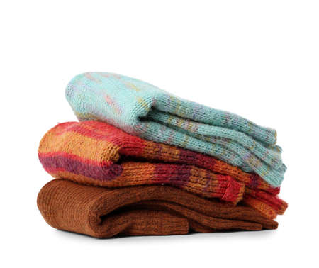 Stack of warm female sweaters on white background