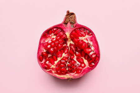 Ripe delicious pomegranate on pink backgroundの写真素材