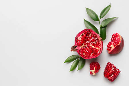 Ripe delicious pomegranate on light backgroundの写真素材