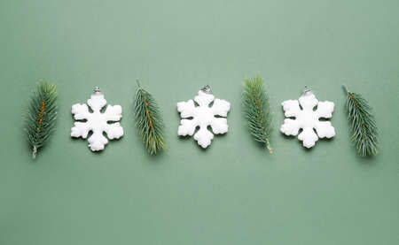 Composition with snowflakes and fir branches on green backgroundの写真素材