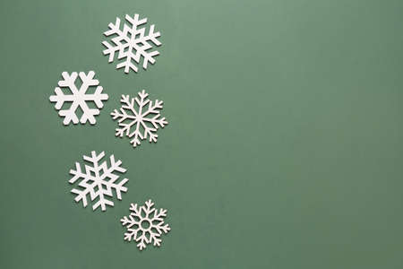 Beautiful different snowflakes on green backgroundの写真素材