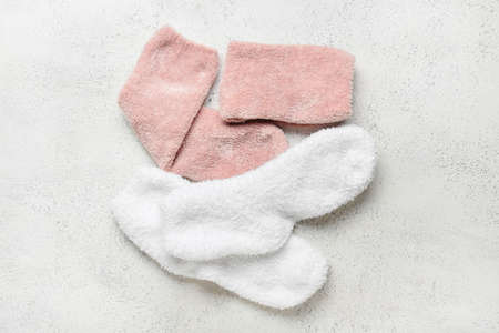 Two pairs of socks on light background