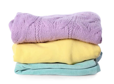 Stack of folded female sweaters on white backgroundの写真素材