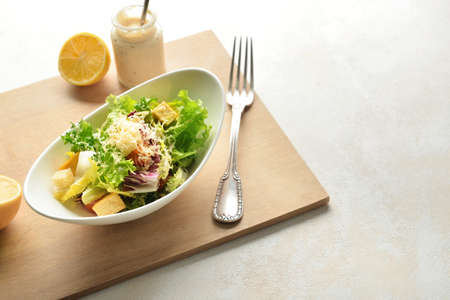 Bowl of tasty vegan Caesar salad on white backgroundの写真素材