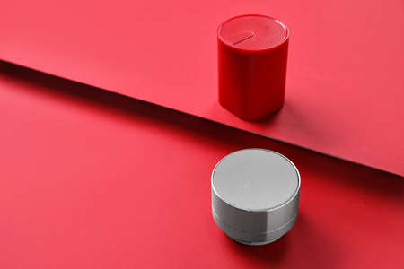 Wireless portable speakers on red backgroundの写真素材