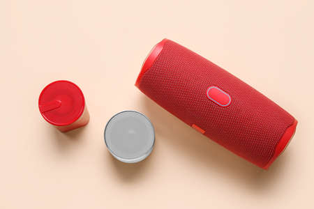 Different wireless portable speakers on color backgroundの写真素材