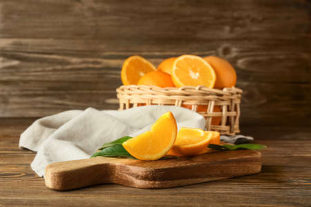 Board with slices of juicy orange on wooden backgroundの写真素材
