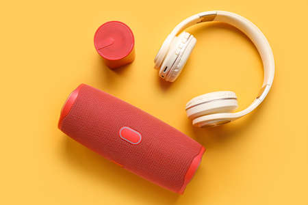 Modern wireless portable speakers and headphones on color backgroundの写真素材
