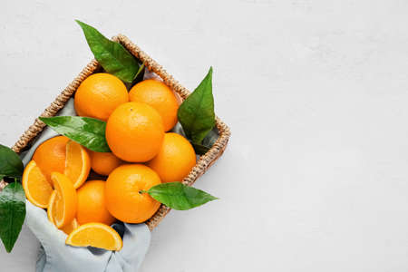 Box with fresh juicy oranges on white backgroundの写真素材