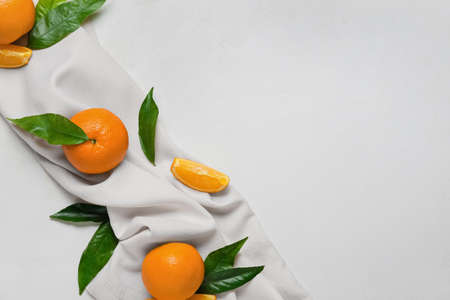 Fresh juicy oranges with leaves on white backgroundの写真素材