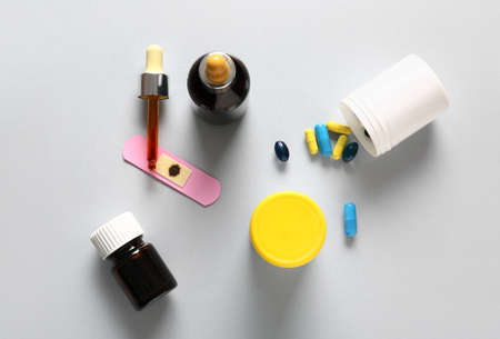Bottles with iodine, medical plaster and pills on gray backgroundの写真素材
