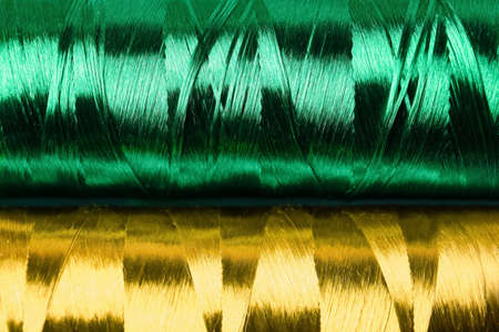 Spools with green silk sewing threads as background, closeupの写真素材