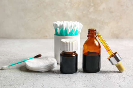 Cotton pad, swabs and bottles with iodine on grunge background