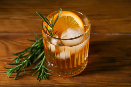 Glass of tasty Old Fashioned Cocktail on wooden backgroundの写真素材