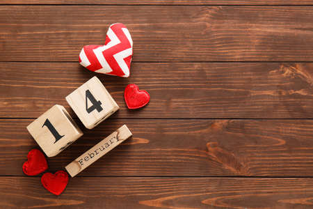 Calendar with date of Valentines Day and fabric heart on wooden backgroundの写真素材
