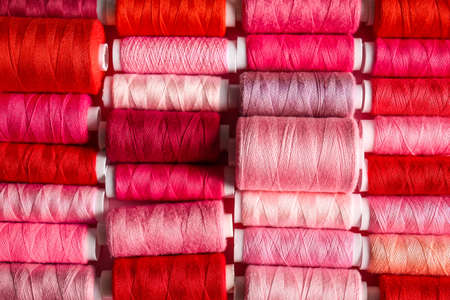 Spools with different sewing threads as backgroundの写真素材