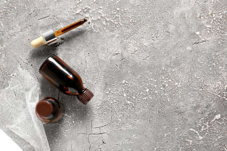 Bottles with iodine, gauze roll and pipette on grunge backgroundの写真素材