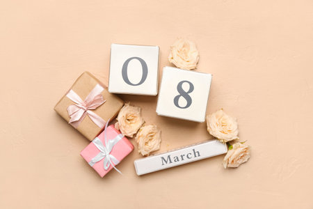 Calendar with date of International Women's Day, flowers and gifts on color background