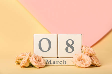 Calendar with date of International Women's Day and flowers on beige backgroundの写真素材