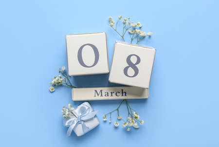 Calendar with date of International Women's Day and flowers on blue backgroundの写真素材